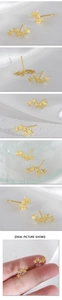 Macro detail van minimalistische gouden ster oorbellen gerangschikt in een boogvorm