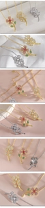Detailed close-up of floral pendant necklaces with inlaid zircons in various colors