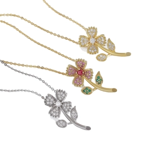 Three dainty zircon floral necklaces in gold and silver finish on white background