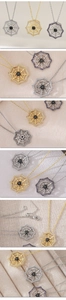 Detailed close-up of a spider web pendant with a black gemstone and crystal trim