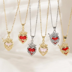 Macro display of six vintage Gothic heart pendants with roses and thorns on silk