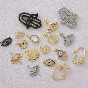 Micro-pave Evil Eye and Hamsa Hand pendants in gold, silver, and gunmetal finishes