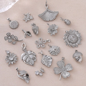 Assorted silver floral pendants with sparkling crystals for DIY jewelry making
