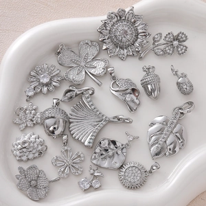 Detailed collection of silver plated flower and leaf pendants with sparkling crystals