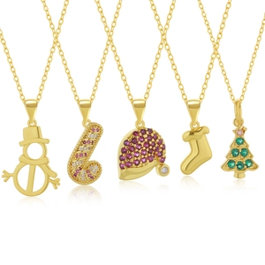 Close-up of 18k gold plated Christmas necklaces with snowman and tree pendants