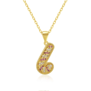 Detail of gold necklace featuring a J-shaped pendant with red and white pavé crystals