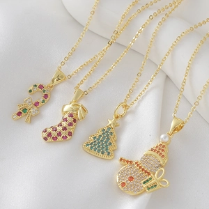 Gold Christmas themed necklaces featuring snowman, stocking, tree, and cane pendants