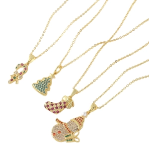 Set of four gold Christmas necklaces with cubic zirconia pendants: tree, snowman and cane