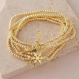 Pulsera de Navidad bañada en oro de 18k con dijes de reno, copo de nieve y muñeco