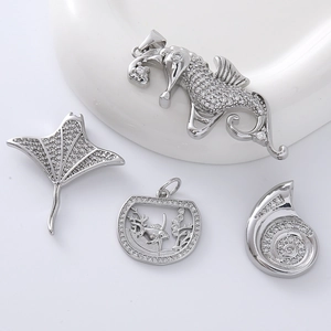 Sparkling silver ocean charms set with cubic zirconia featuring seahorse and shell designs