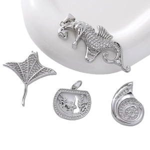 Sparkling silver marine pendants with seahorse and shell designs paved with zircons