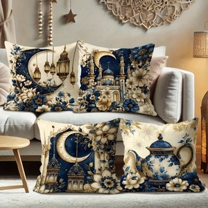 Set of four navy and gold Ramadan pillow covers with crescent and mosque motifs on a sofa