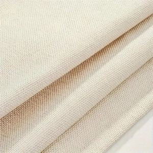 Close-up of thick beige linen fabric showing the detailed weave and natural texture