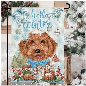 Detail of hello winter garden flag with golden dog and snowy cabin scene decoration