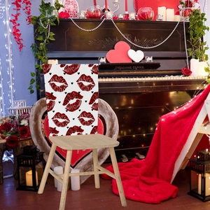Detail of white chair cover with leopard print lip pattern in a romantic setting