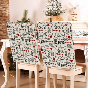 Detail of linen chair covers featuring romantic Love motifs and red hearts for home decor