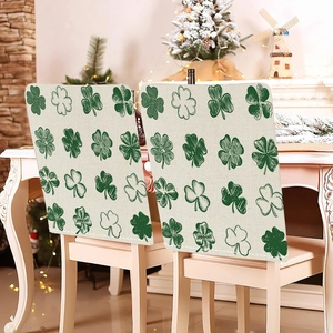 Saint Patrick's Day chair back covers with green shamrock pattern on beige fabric
