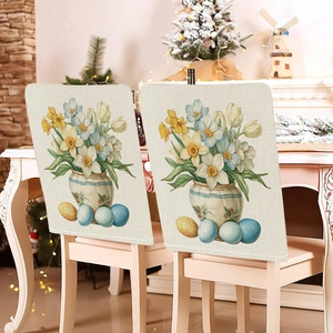 Detail of floral Easter bunny chair covers on white dining chairs with festive decor