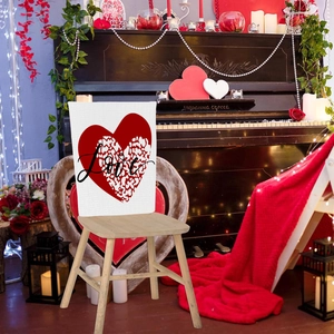 Detail view of Valentine chair cover with red leopard heart and black cursive Love text