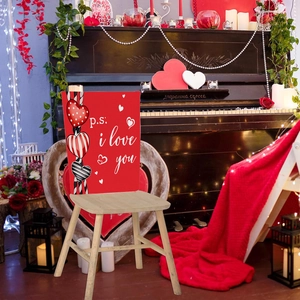 Detail of red Valentine chair cover featuring P.S. I Love You text and heart charms