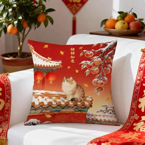 Detail of red festive cushion cover with cat and persimmon tree on a white sofa