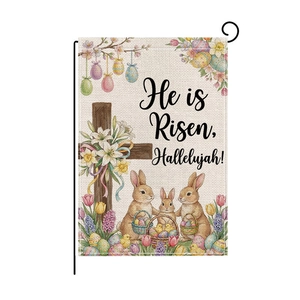 Detail of burlap Easter garden flag featuring rabbits and He is Risen Hallelujah text