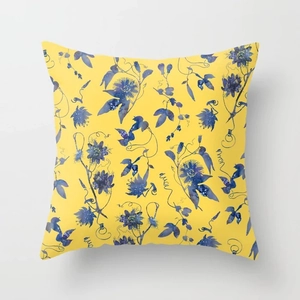 Detail of yellow throw pillow cover with dark blue watercolor floral patterns