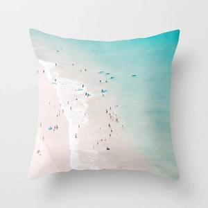 Detail of peach skin pillowcase with a colorful realistic beach surfing landscape print