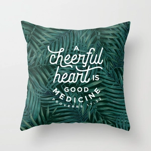 Detail of tropical palm leaf pillow cover with white inspirational quote print