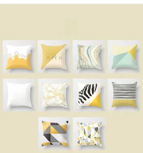 Collection of modern geometric throw pillow covers in yellow, grey, and white palette