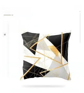 Detail of modern square pillowcase with geometric black white and gold patterns