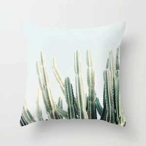 Detailed texture of peach skin cushion cover featuring fresh green cactus print