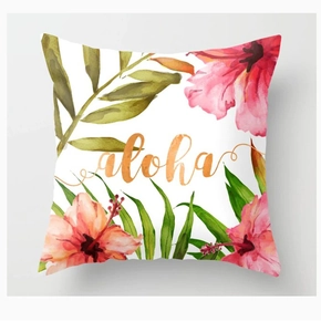 Detail of floral peach skin cushion cover with hibiscus print and aloha typography