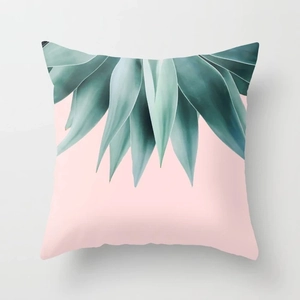 Detail of square peach skin pillow cover with pink background and green succulent print