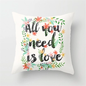 Floral print pillow cover with All You Need Is Love text on white peach skin fabric