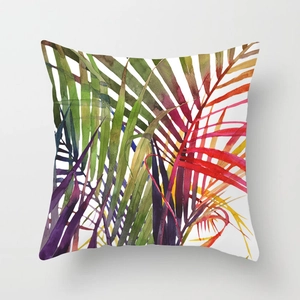 Detail of vibrant tropical palm leaf watercolor pattern on a square throw pillowcase