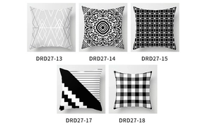 Close-up of peach skin pillow covers featuring black and white Nordic geometric patterns