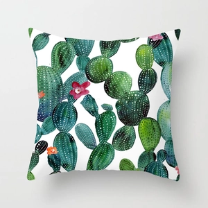 Detail view of tropical cactus watercolor print on soft peach skin pillow cover