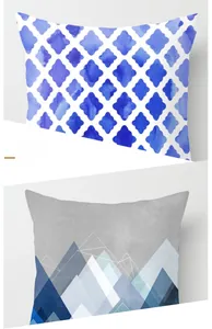 Detail showing blue watercolor clover pattern and modern geometric mountain pillow covers