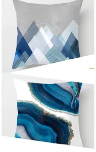 Detail of peach skin decorative pillows with blue abstract mountain and marble textures