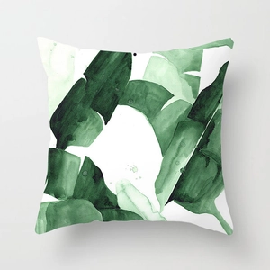 Detailed macro view of tropical banana leaf print on white peach skin fabric pillow cover