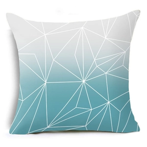 Close-up of geometric polygon pattern with teal gradient on decorative throw pillow