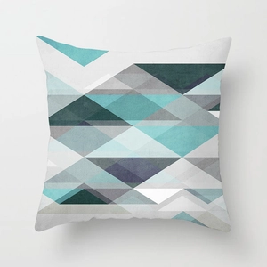 Close-up of geometric pattern on Nordic style square pillowcase with turquoise and grey shapes