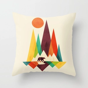 Detail of square cushion cover with minimalist sunrise mountains and bear silhouette
