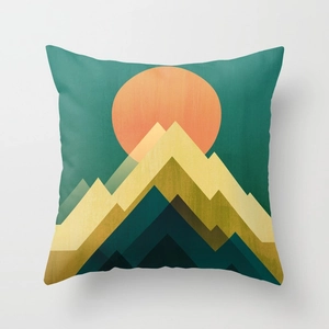 Macro detail of decorative square pillow with modern abstract mountain sunrise pattern