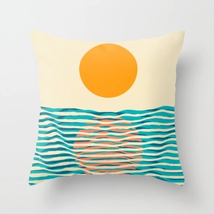 Detail of decorative pillow case with minimalist orange sunrise and teal ocean waves pattern