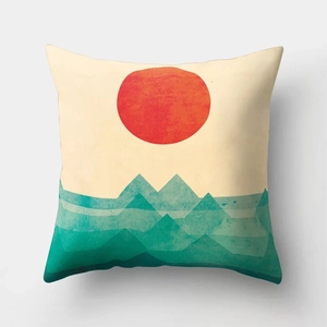 Detail of soft square cushion cover featuring a minimalist red sun and teal mountain art