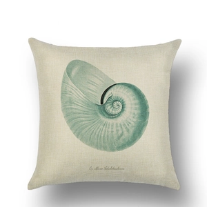 Detail view of linen pillow cover showing a vintage hand-painted green nautilus shell