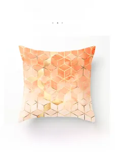 Detail of soft peach skin polyester fabric with orange and pink geometric cube patterns