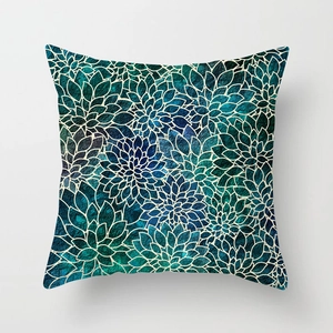 Detailed close-up of geometric green plant pattern on soft peach skin cushion cover